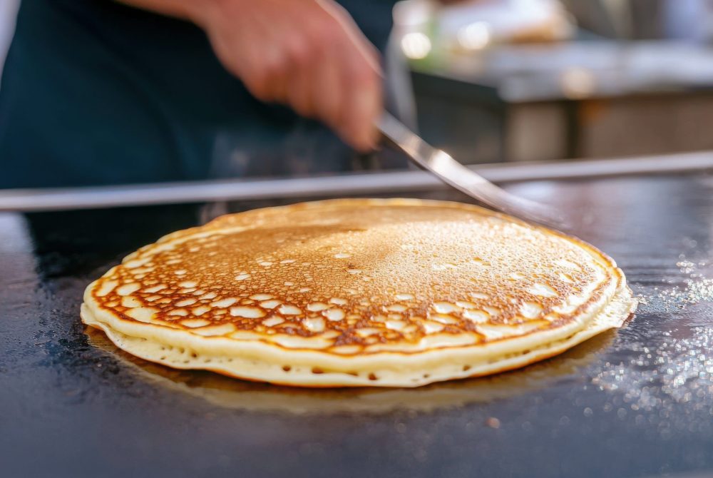 Gourmet Pancake Stand at the Festival Offering Unique Pancakes and Delicious Flavors to Enjoy A gourmet pancake stand at a lively festival showcases the art of pancake cooking, serving fluffy creations with diverse flavors in a festive atmosphere.